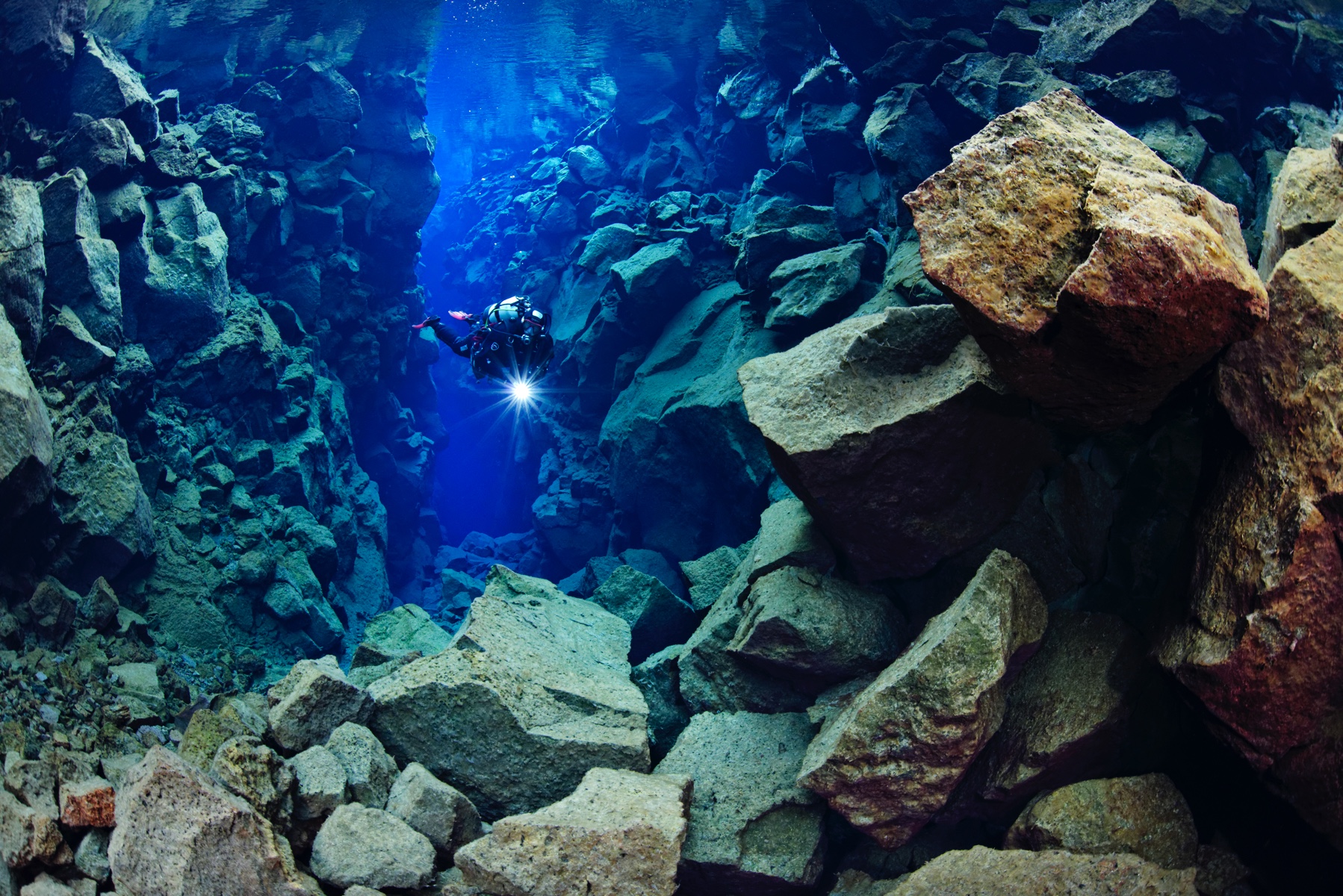 Diver enjoying his dive in the clearest water in the world at Silfra fissure, Iceland