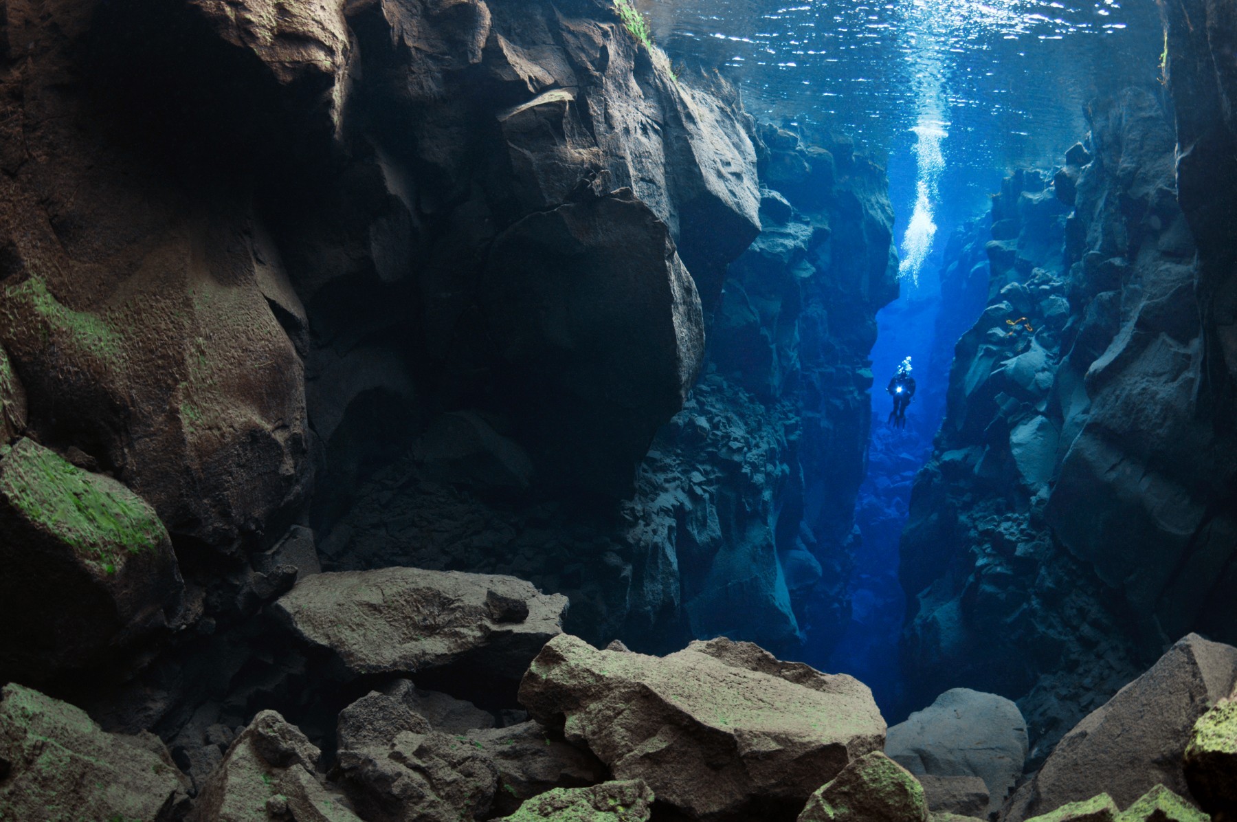 Diver descending into Silfra, Thingvellir
