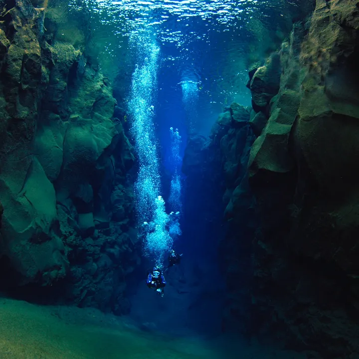 two-diver-approach-sandy-slope