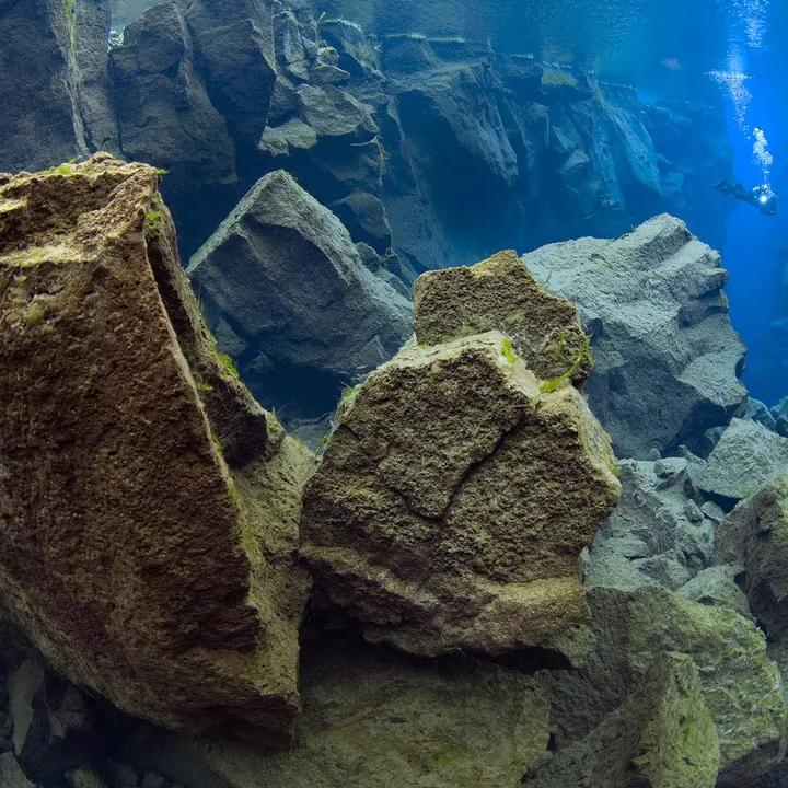 diver-coming-out-of-the-cathedral-in-silfra-thingvellir-iceland-magnus-lundgren