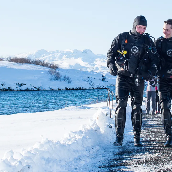 Happy divers walking back from the exit platform after their Dive in Silfra, Iceland
