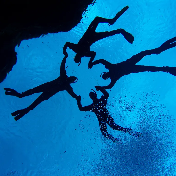 snorkelers-posing-photographer-silfra-iceland-dive-is.jpg