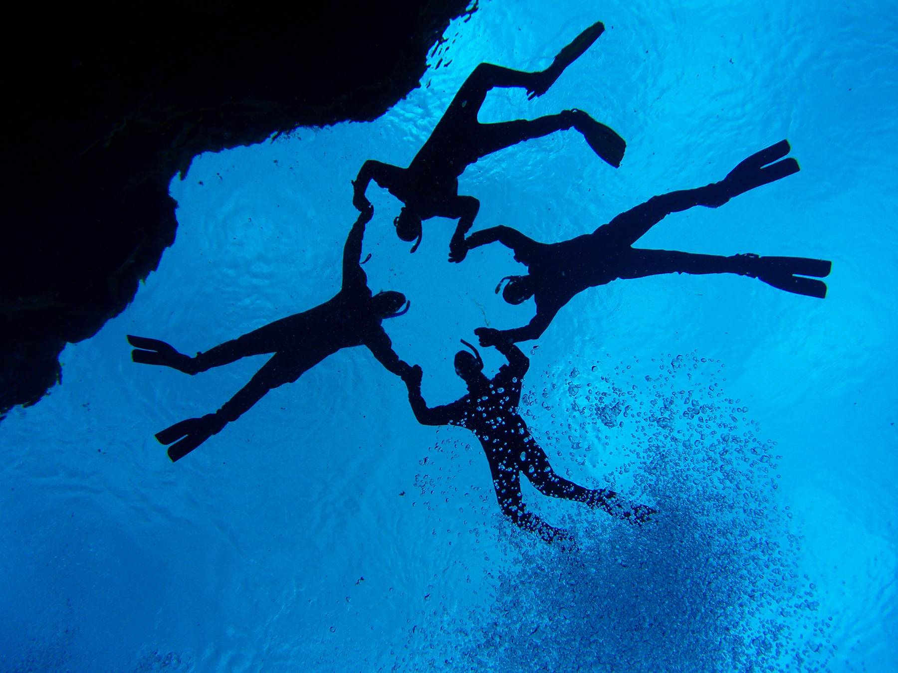 Snorkelers posing together for DIVE.IS photographer in Silfra, Iceland