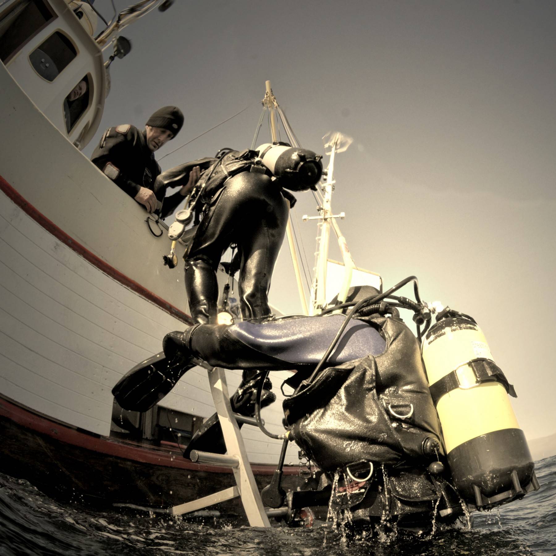 Divers returning to the yacht after a dive near Hornstrandir, Iceland Boat dives near Hornstrandir, Iceland