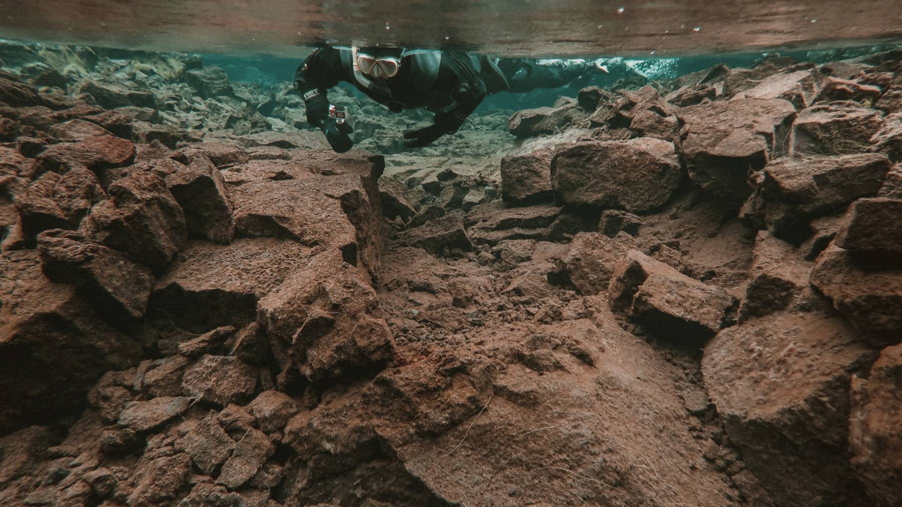 snorkeling-rock-formation-crystal-clear-silfra