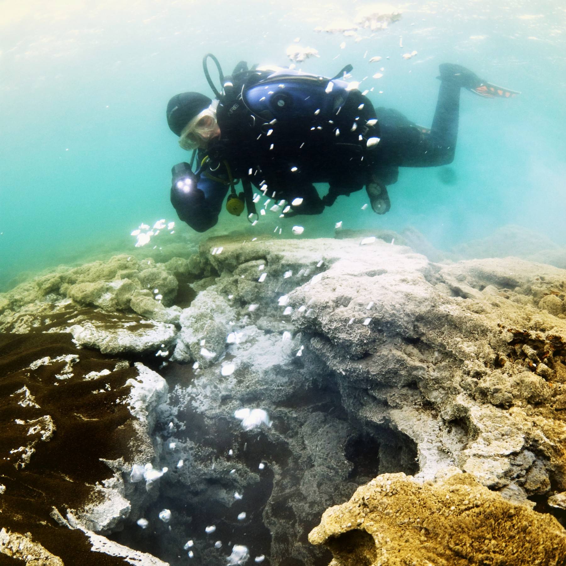 A diver explores the bubbling underwater hot springs in Kleifarvatn Lake, Iceland