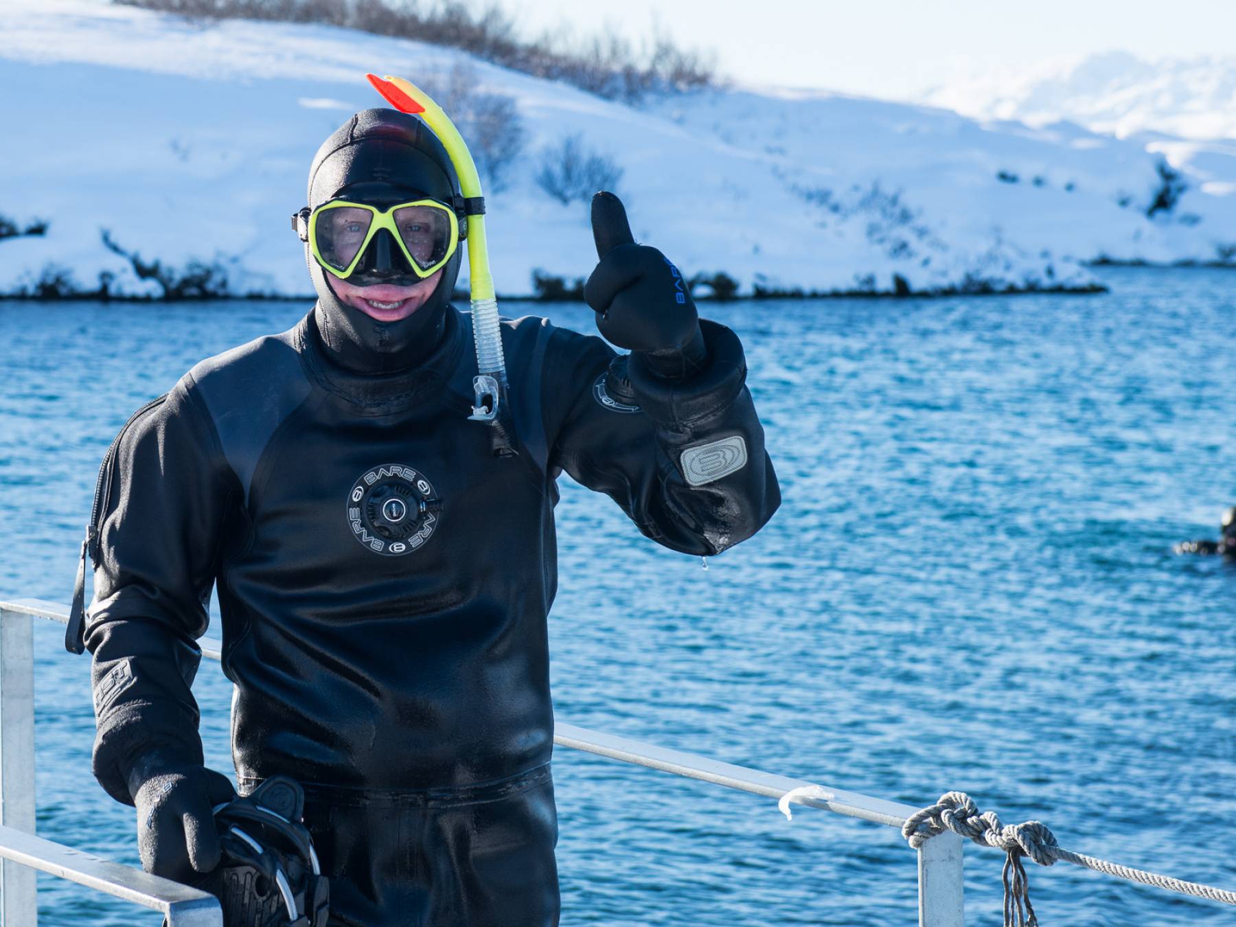 thumbs-up-from-a-silfra-snorkeling-guide-in-winter-in-iceland.jpg