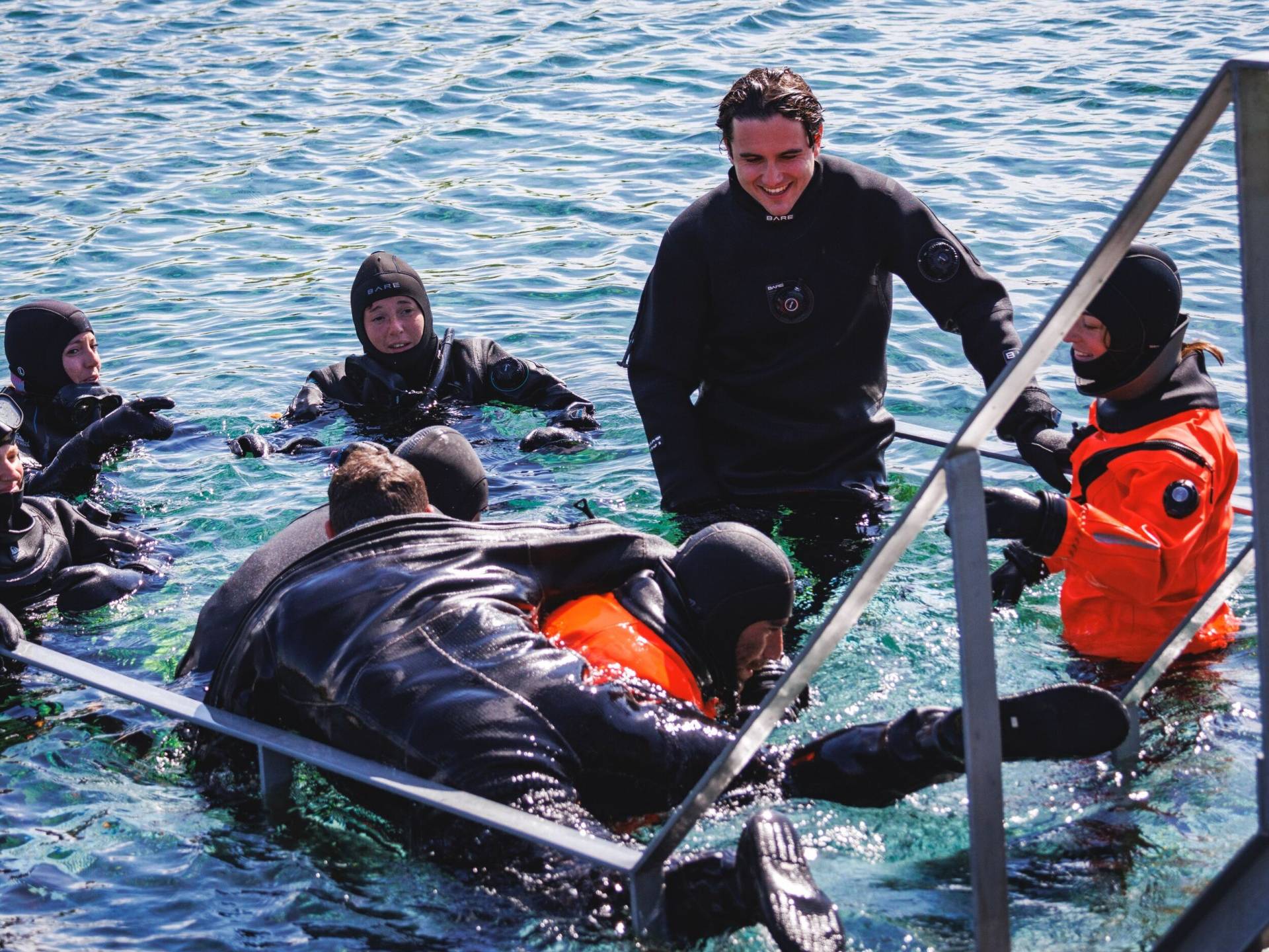 Divers practicing in-water rescue in full dive gear