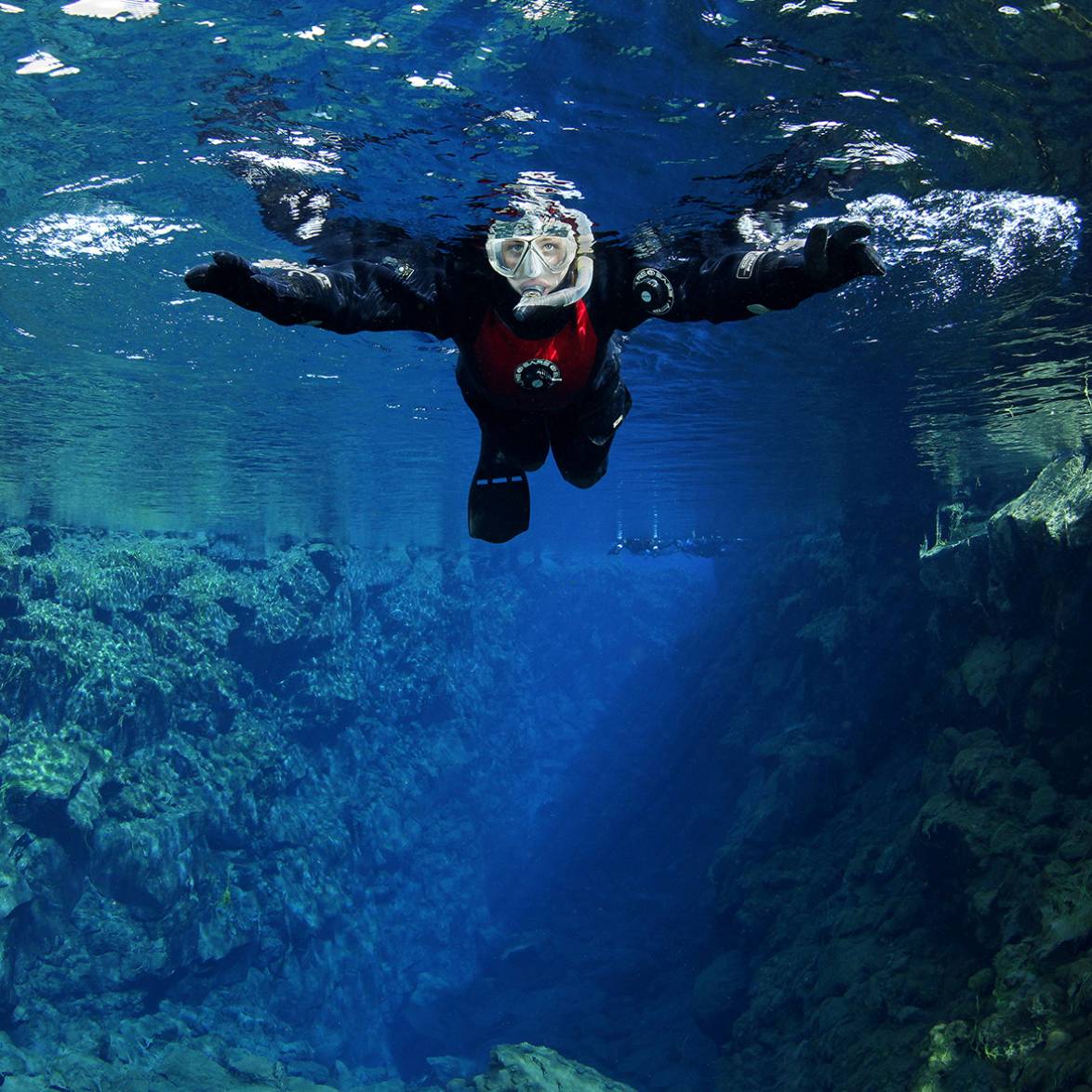 Snorkeler in Silfra hall, Thingvellir, Iceland snorkeler-silfra-hall-thingveliir-iceland-tobias-friedrich