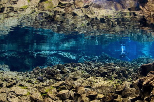 Scuba diving in beautiful rock scenery in the clear water in Silfra fissure in Iceland