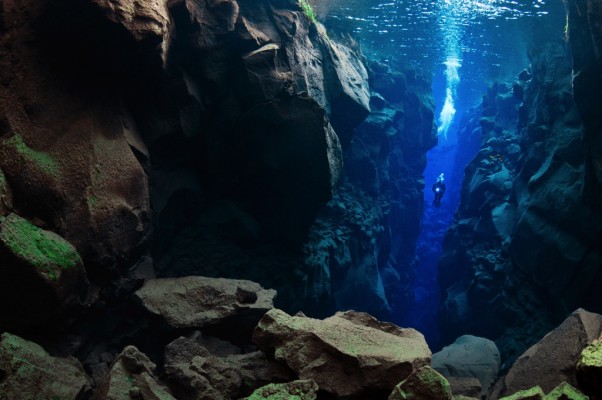A scuba diver seen from afar in the Silfra Cathedral in Iceland