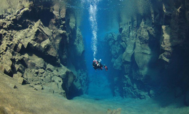 Scuba diver diving in Silfra Cathredal