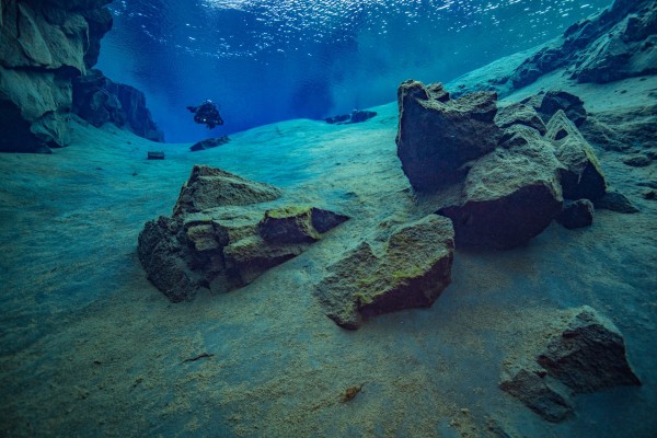 A scuba diver having a private moment in Silfra fissure in Iceland