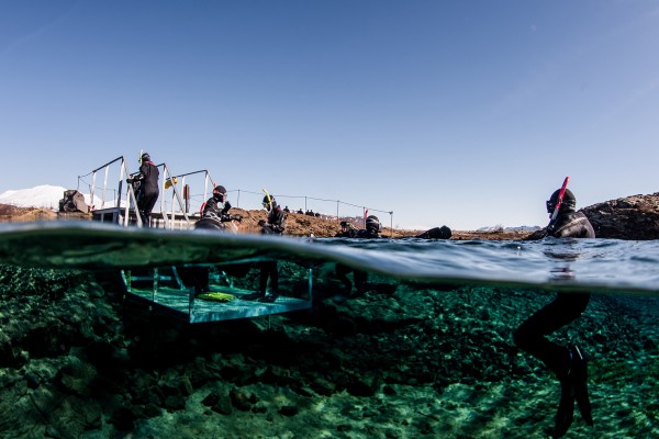 Split-view of snorkelers exiting the platform in Silfra Lagoon after their snorkel tour