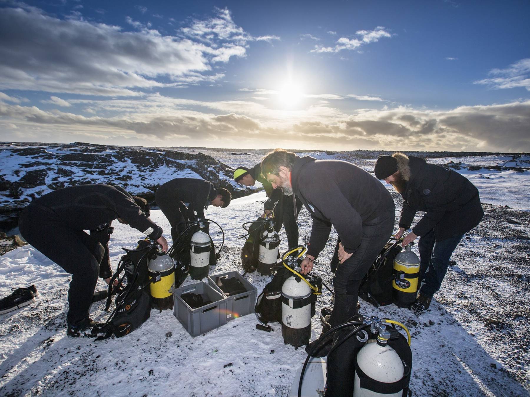 A dry suit diver course on a beautiful Icelandic winter day Dry suit course students and their instructor assembling dive equipment